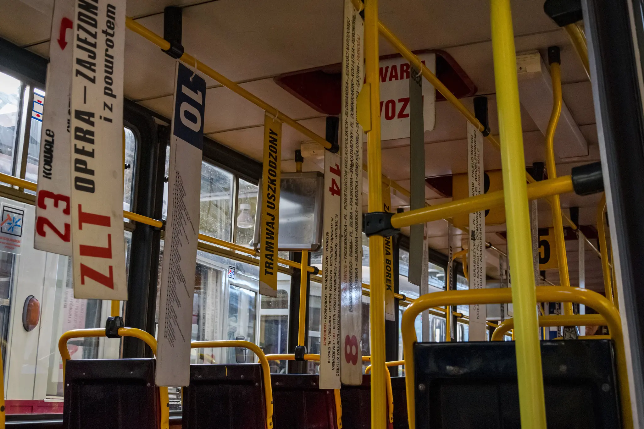 Inside of a bus with lots of destination boards