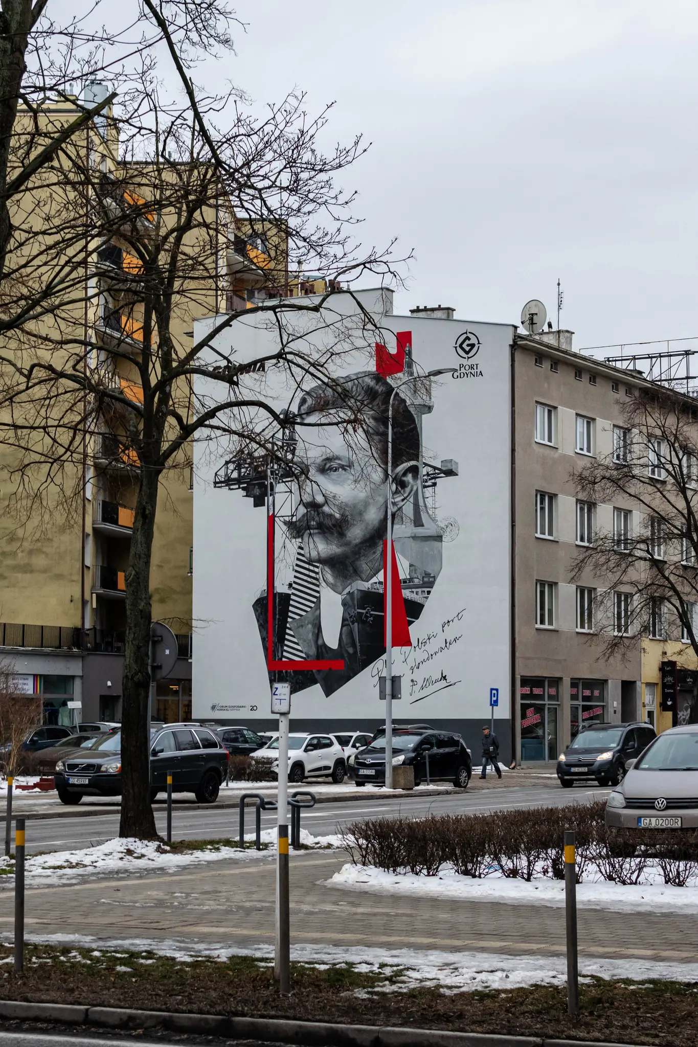 building with a mural depicting a person and a ship, commemorating building of a port