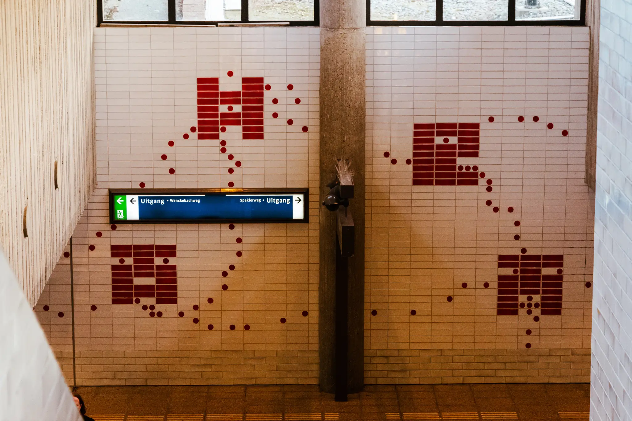 Wall mosaic with something that looks like a pacman game map or something I don’t know I am not versed in art