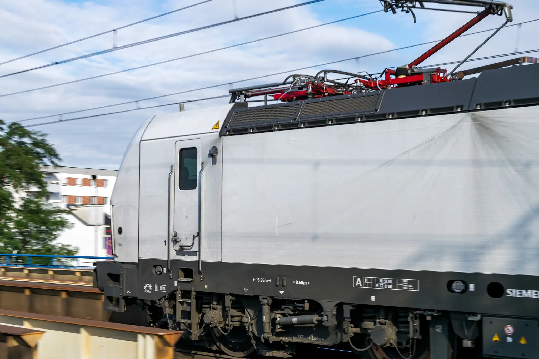 White vectron speeding past the station