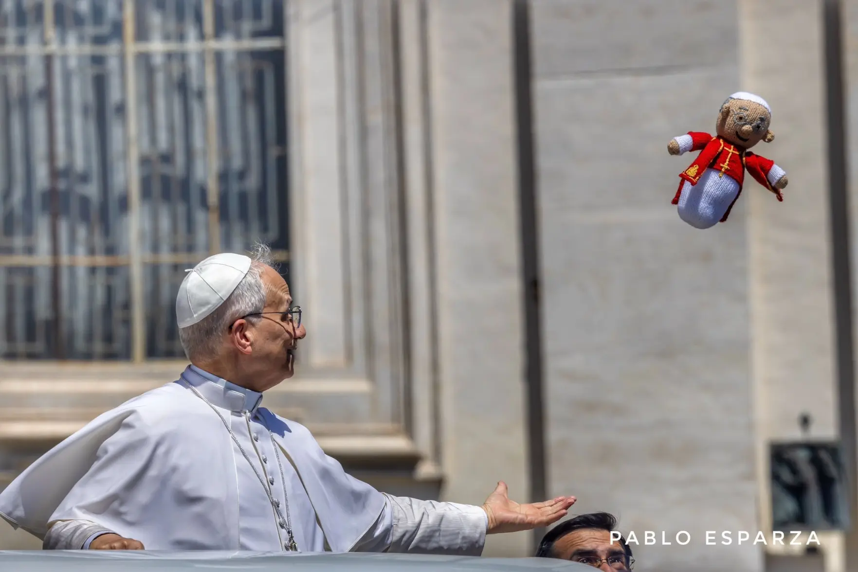 photo of the pope waiting to receive airborne handmade plushie of himself that was thrown at him