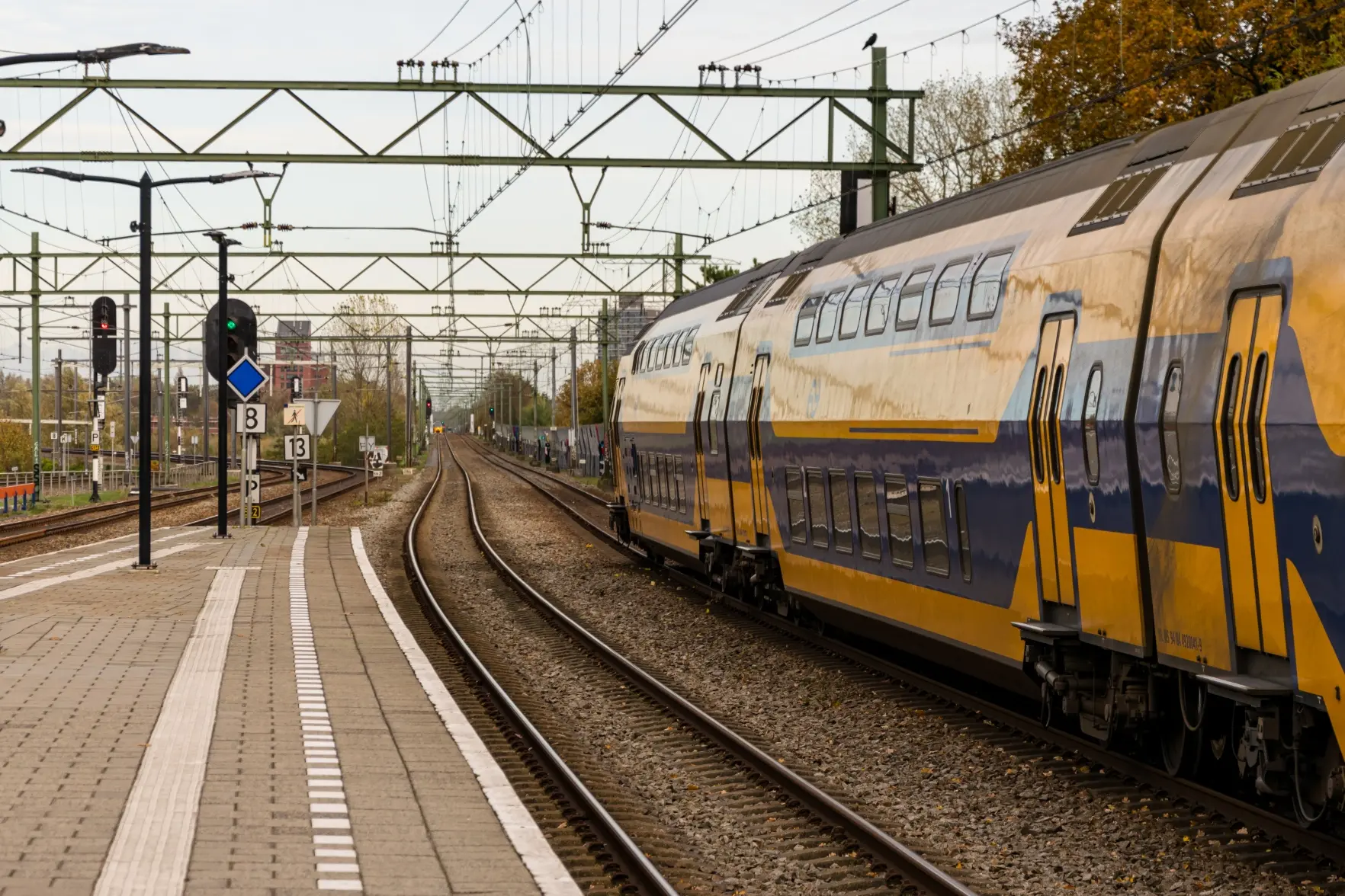 yellow-blue train leaving the station