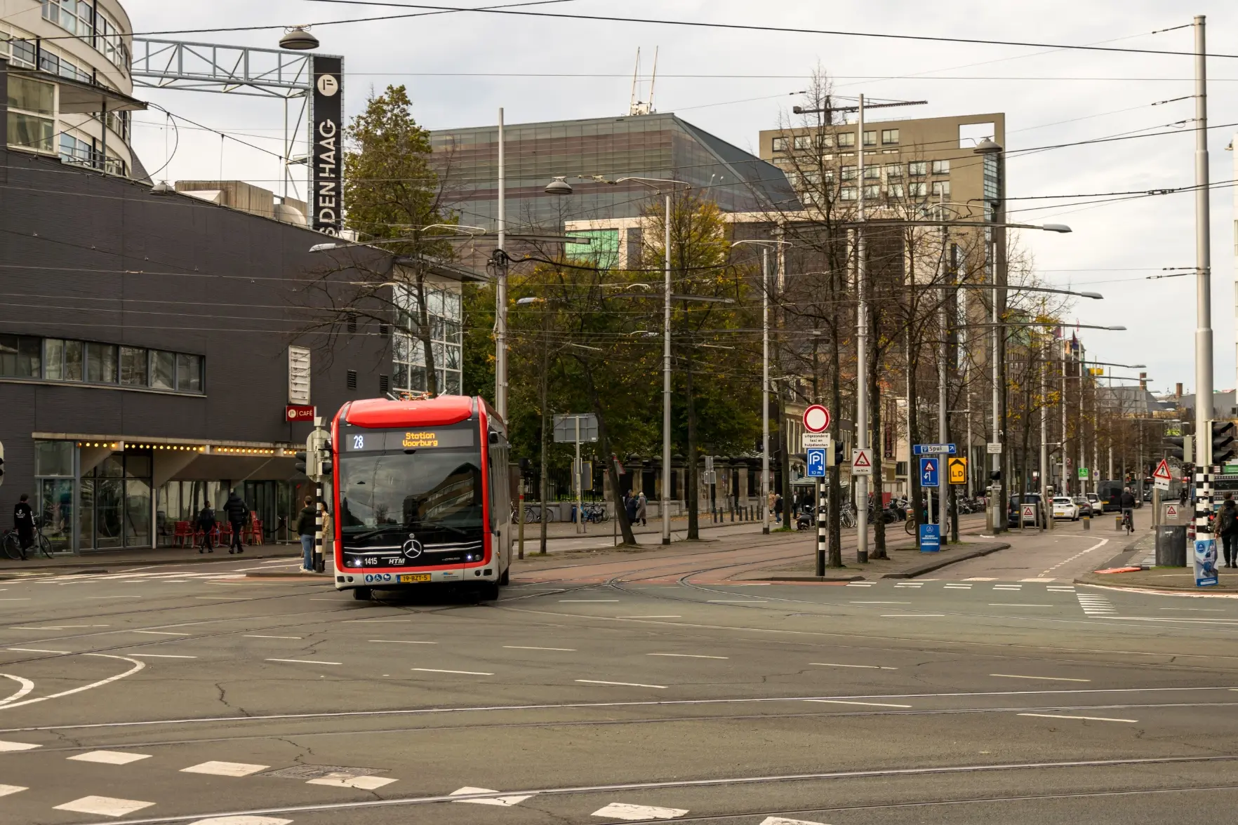 red bus turning at a junction
