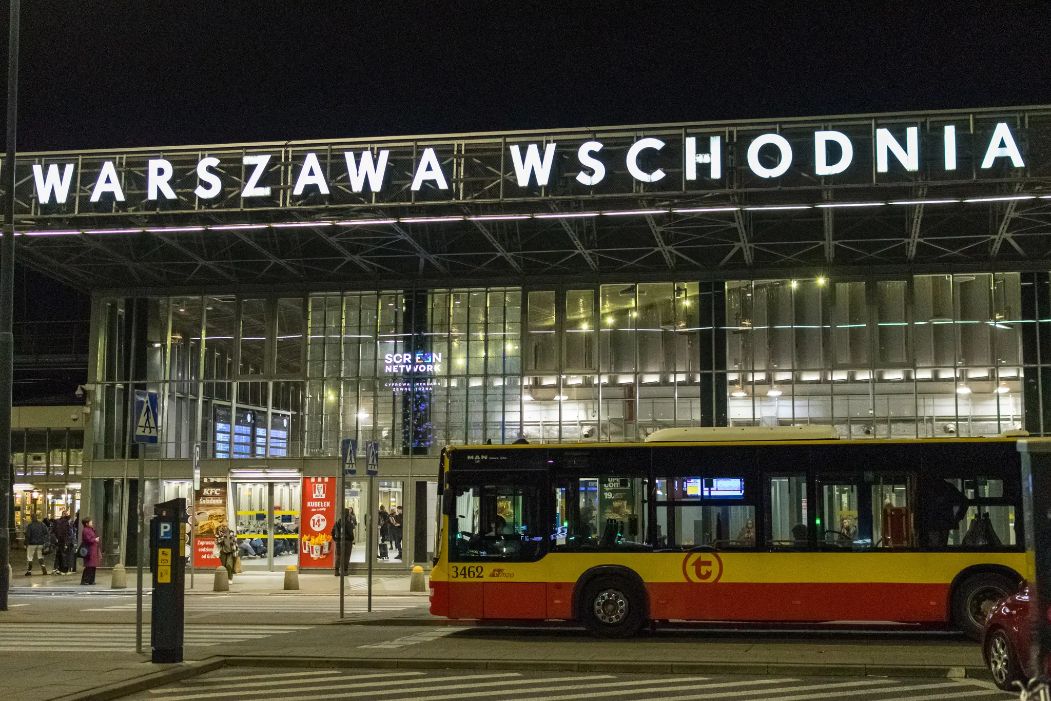 Entrance to Warszawa Wschodnia train station at night, there’s a bus waiting for departure