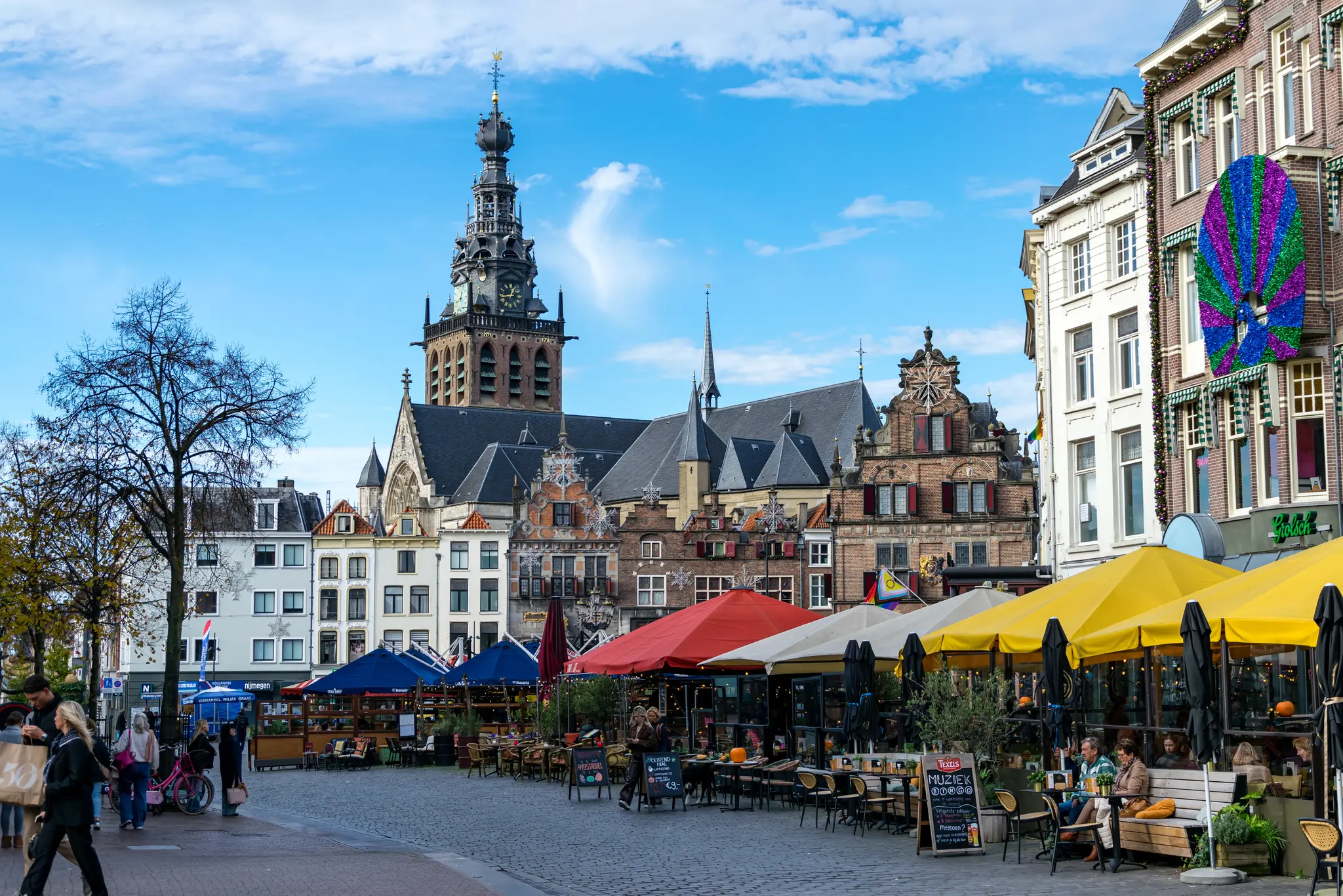 What I assume is or was a market square at some point, lots of old tall-ish buildings and a big church tower looming over, lots of restaurant gardens as well