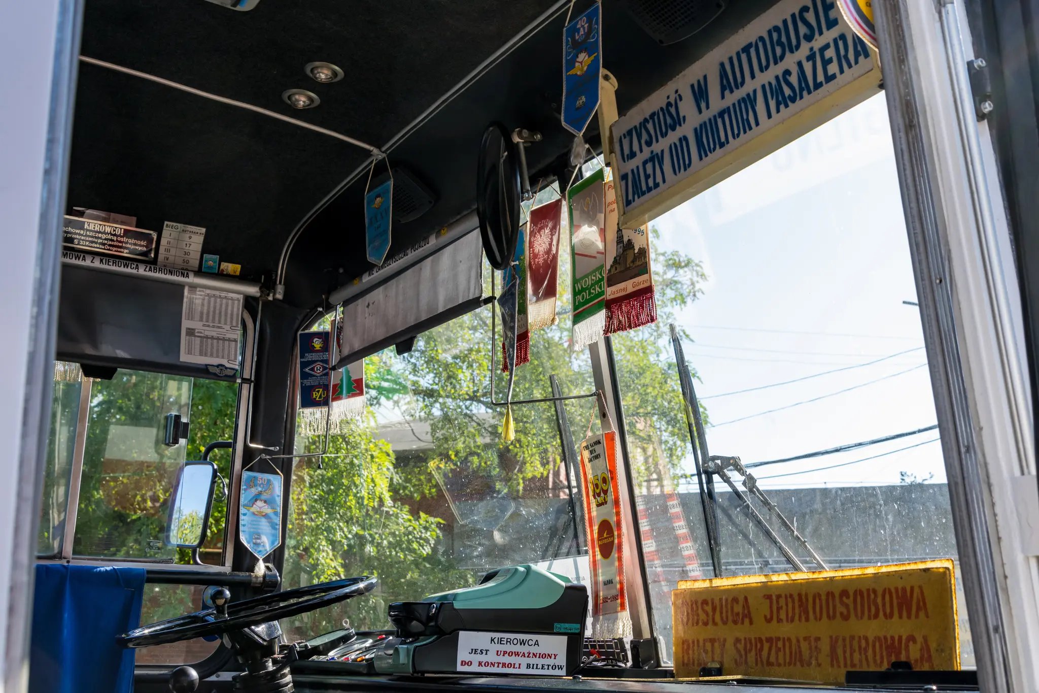 Interior of a PKS bus with lots of pennants and boards