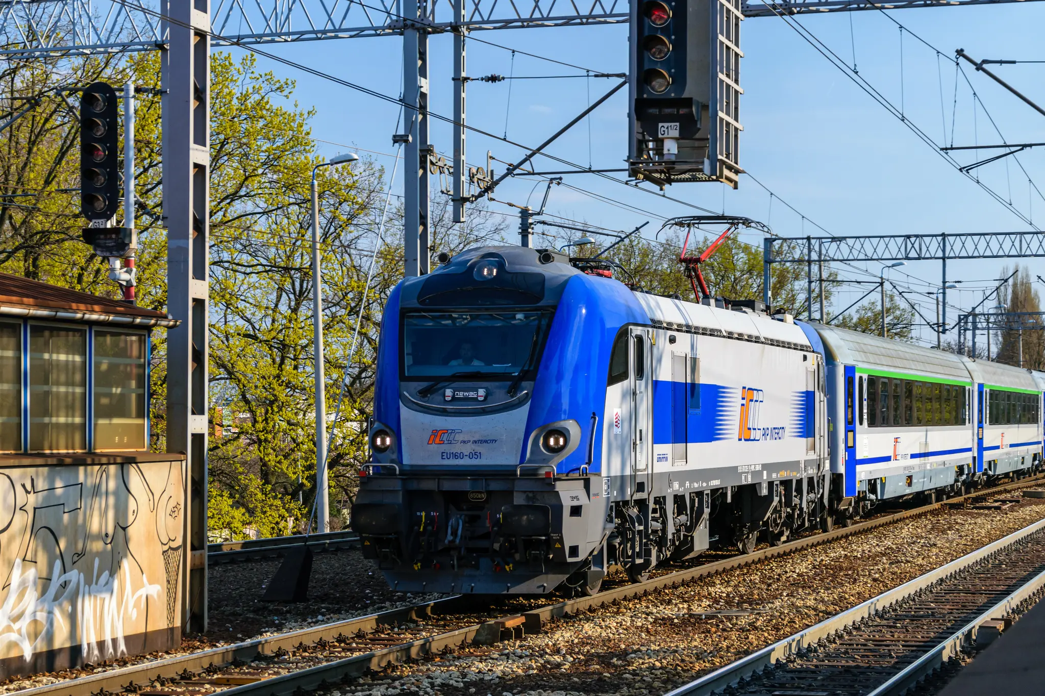 Blue-silver locomotive pulling multiple silver-blue coaches