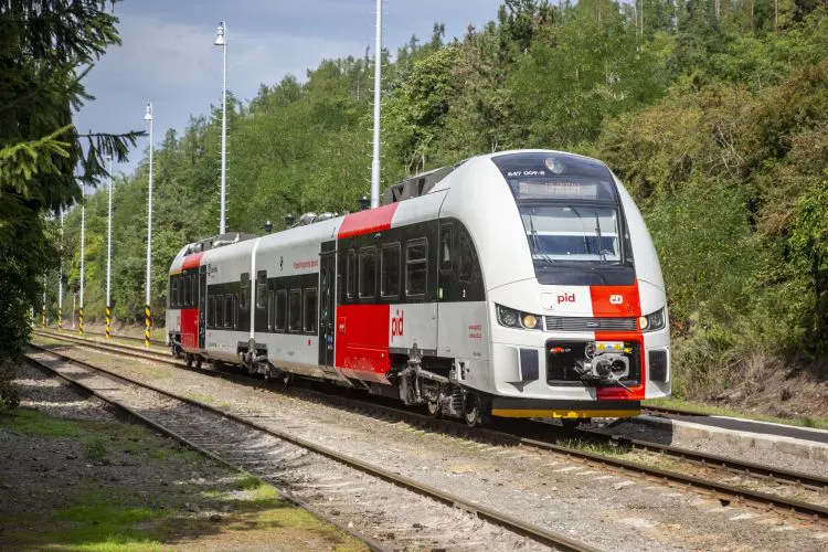 Two-car articulated diesel train in grey with big red vertical stripes livery