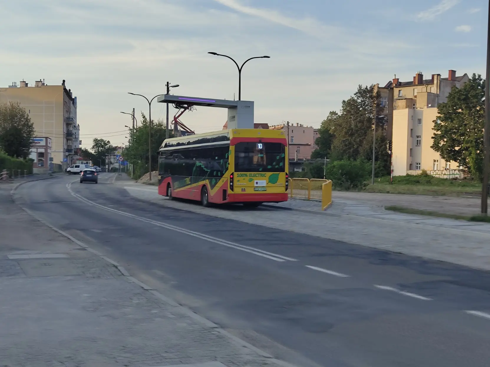 Electric bus charging batteries with a pantograph