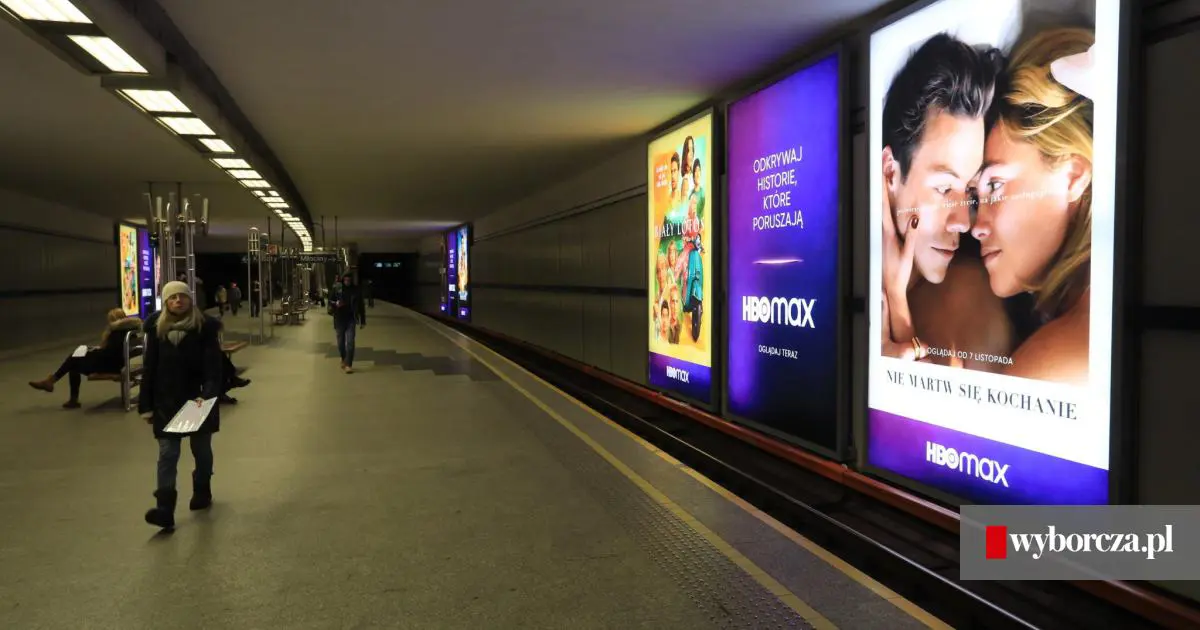 metro station with huge ad displays opposite to platform